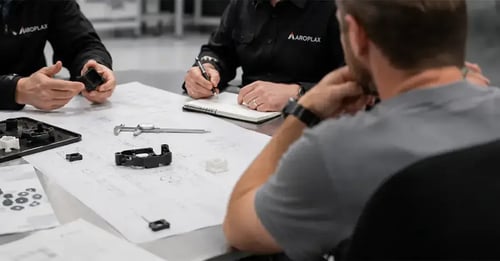 group of aroplax employees reviewing a design